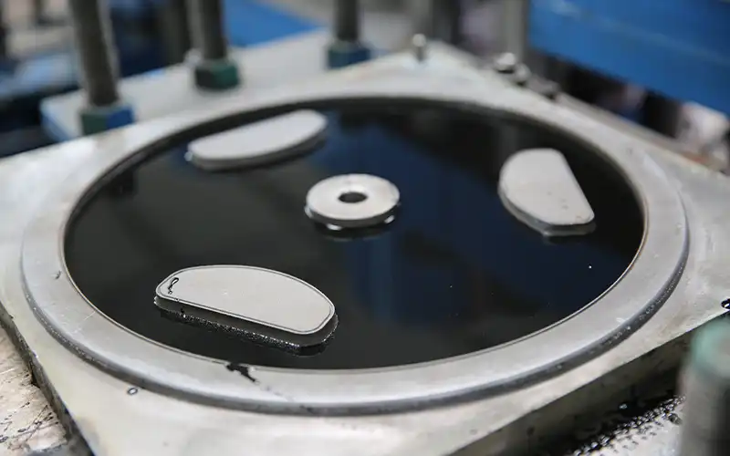 Close-up of rubber coating application process for dumbbells at ShuangJia factory